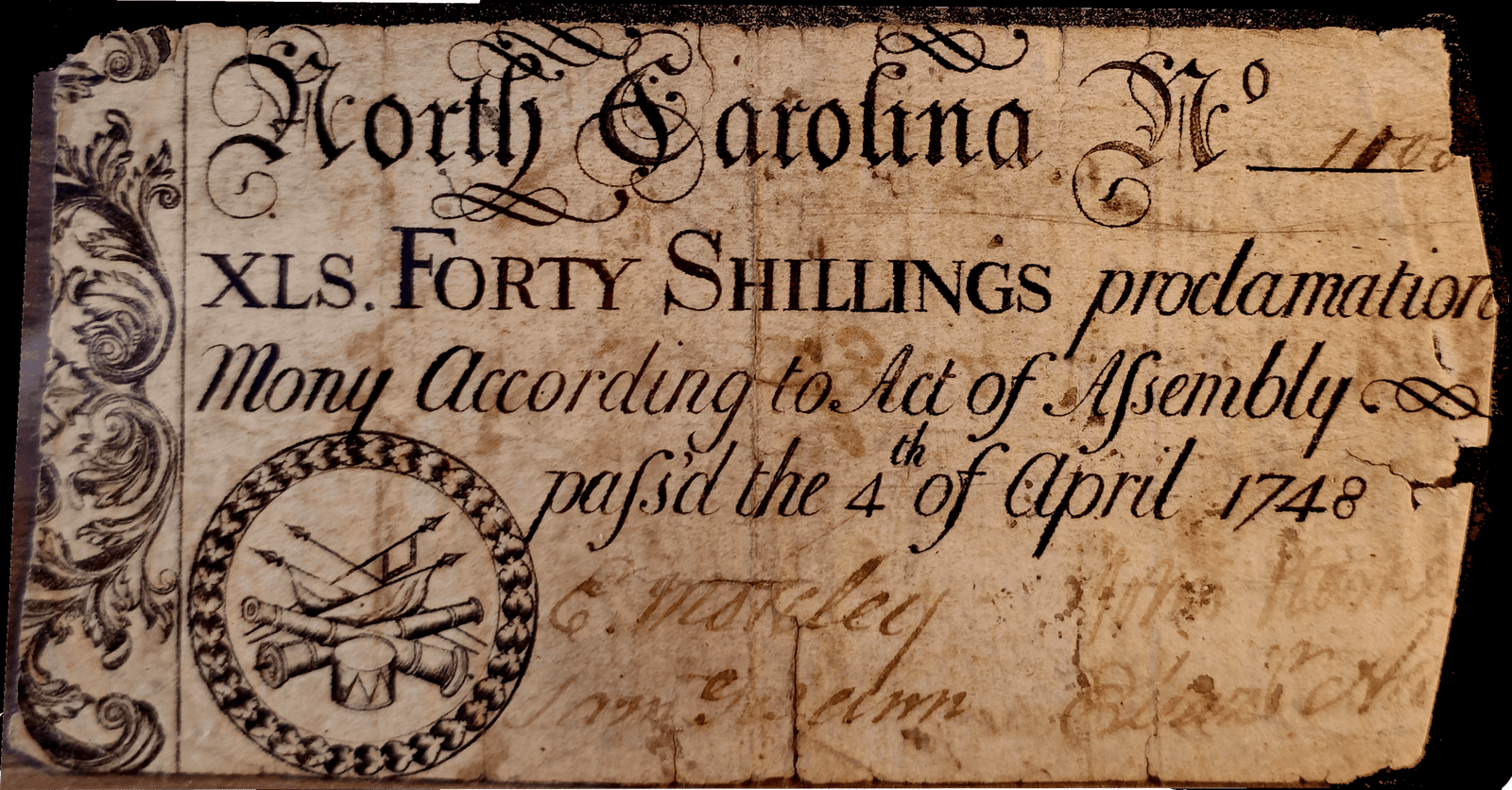 Old North Carolina currency, 1748, forty shillings, ornate design with arrows and drums seal.
